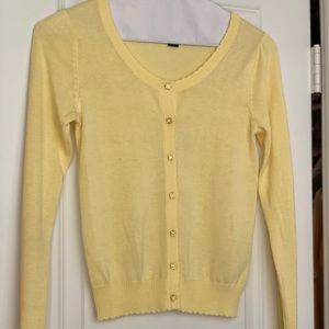 Yellow sweater with flower buttons